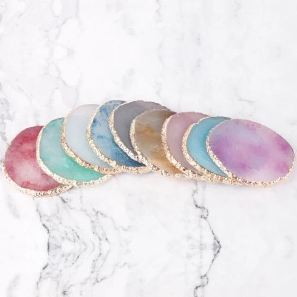 Colorful_round_agate_stone_coasters_with_gold_edges_on_marble