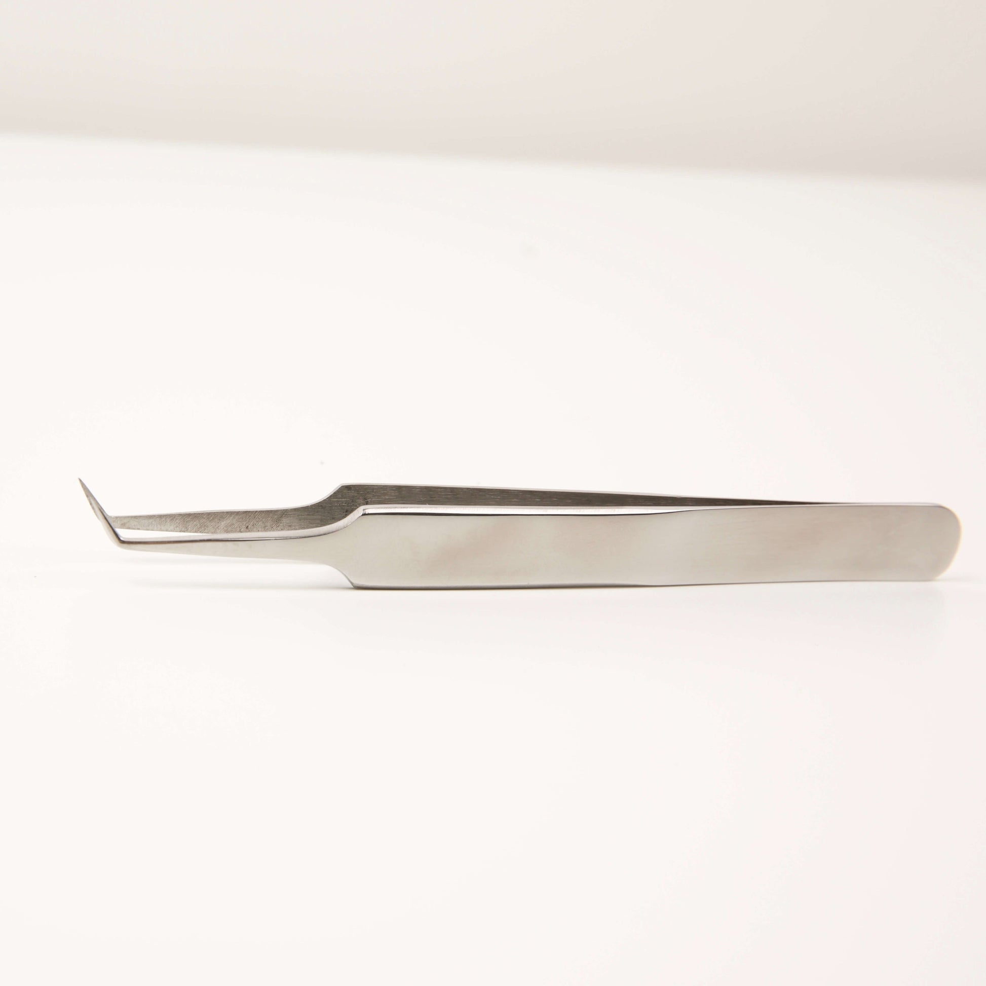 Angelash_silver_tweezers_on_white_background