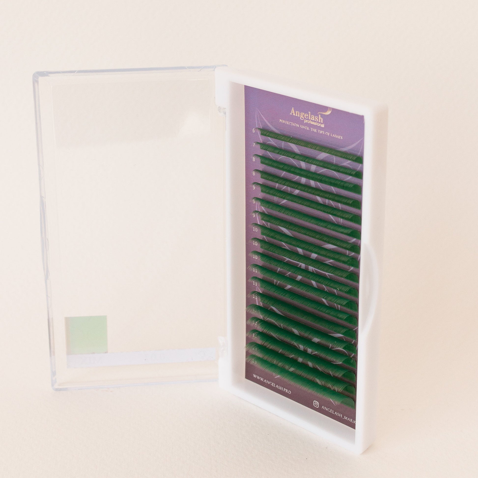 Green_colored_eyelash_extensions_in_open_tray_with_clear_lid